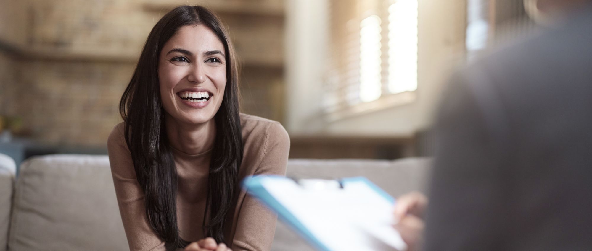 A woman learning about the outpatient therapy programs at Boston Addiction Treatment, a rehab center in Peabody, MA.
