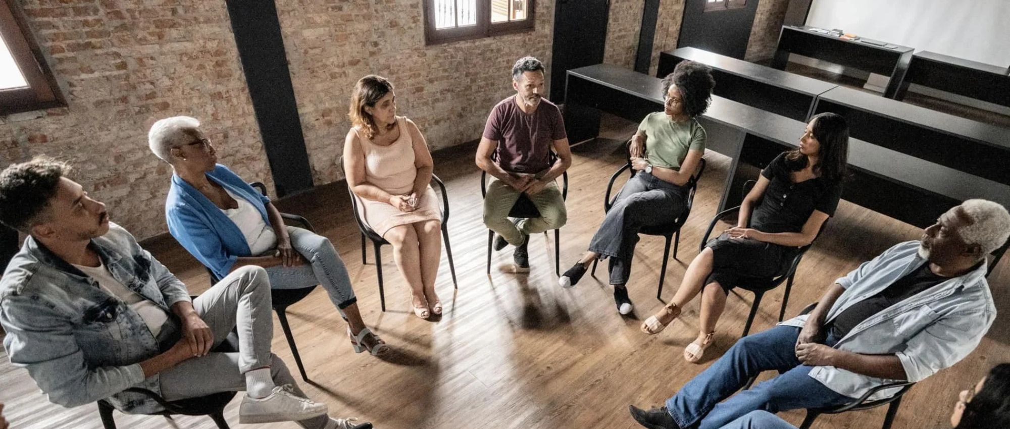 A group of adults getting outpatient cocaine addiction treatment through a group therapy session at Boston Addiction Treatment, a rehab center in Peabody, MA.
