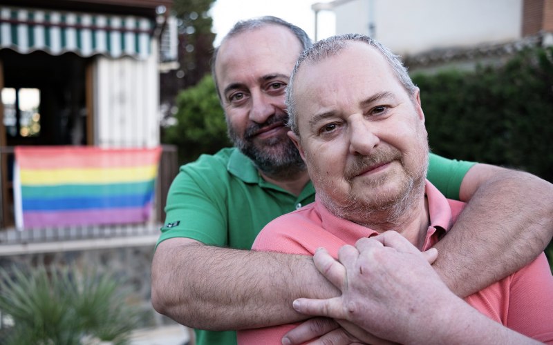 two men embracing, pleased with their life in sobriety
